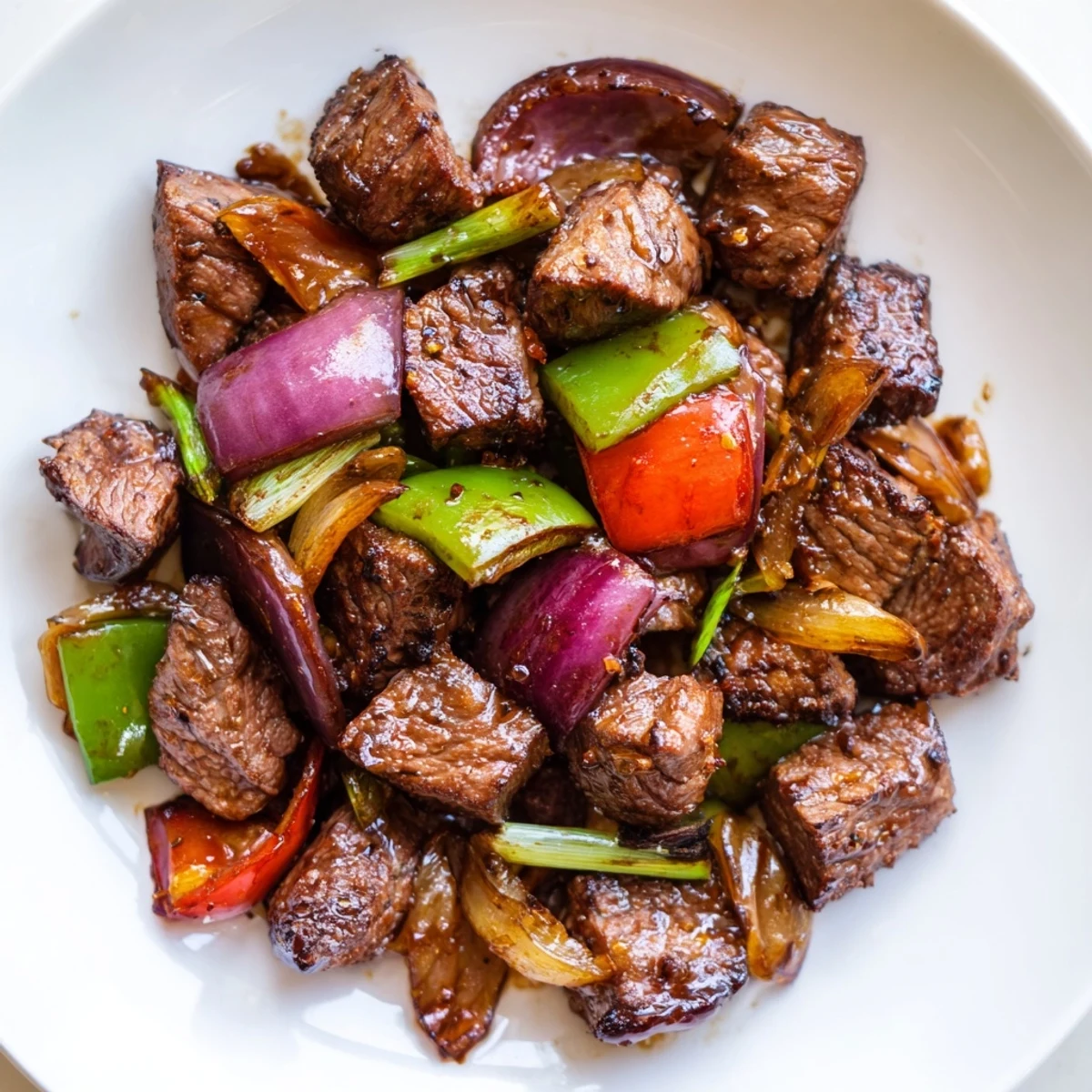 Colorful platter of Vietnamese Shaking Beef with beefy aroma, steamed rice and tangy lime sauce.