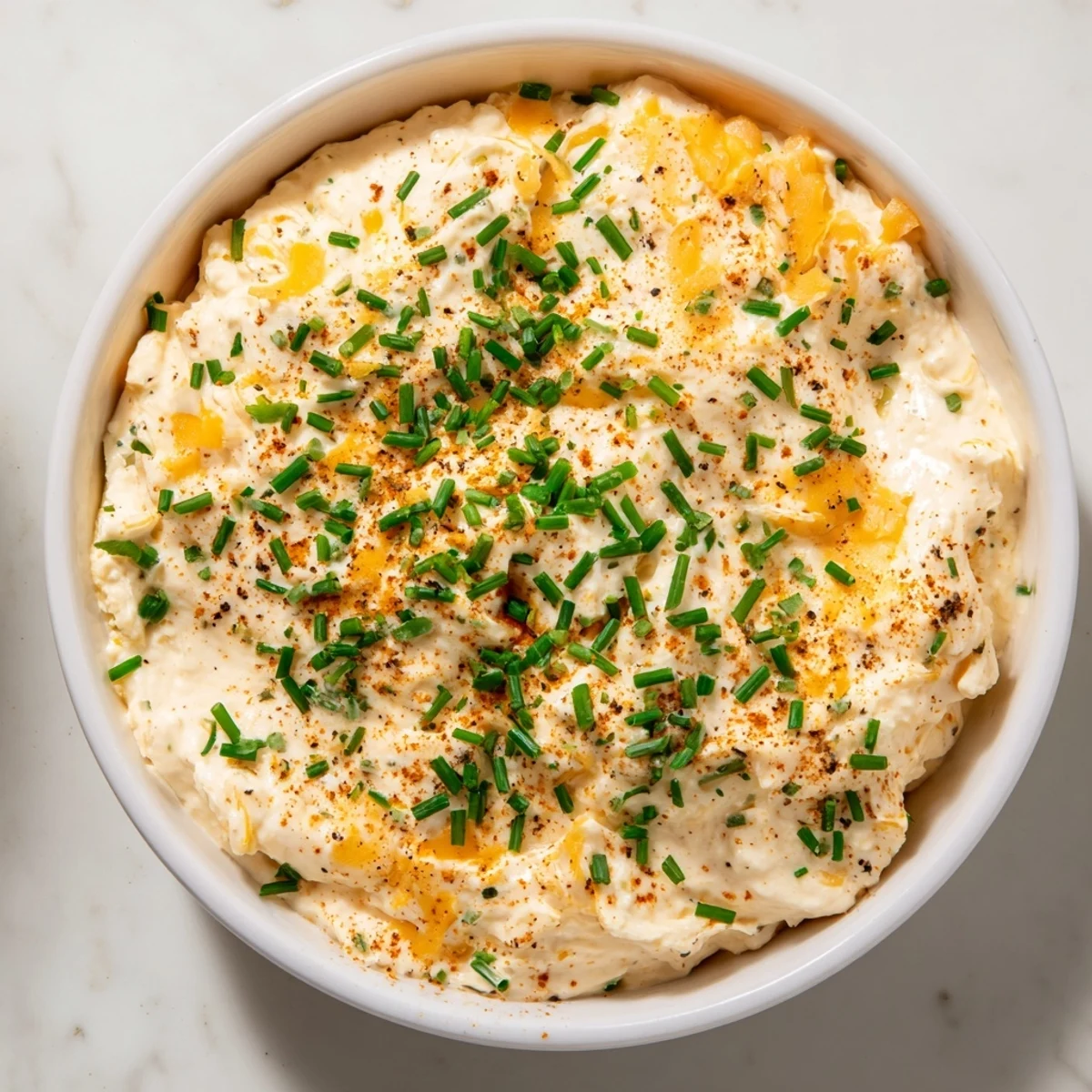 Golden soft pretzels arranged around a bowl of homemade savory pretzel dip