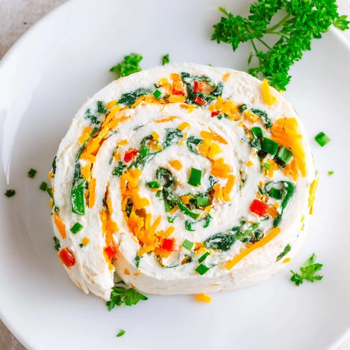 Party-ready cream cheese pinwheels arranged on a platter featuring creamy herb and cheese spread in spiral pattern