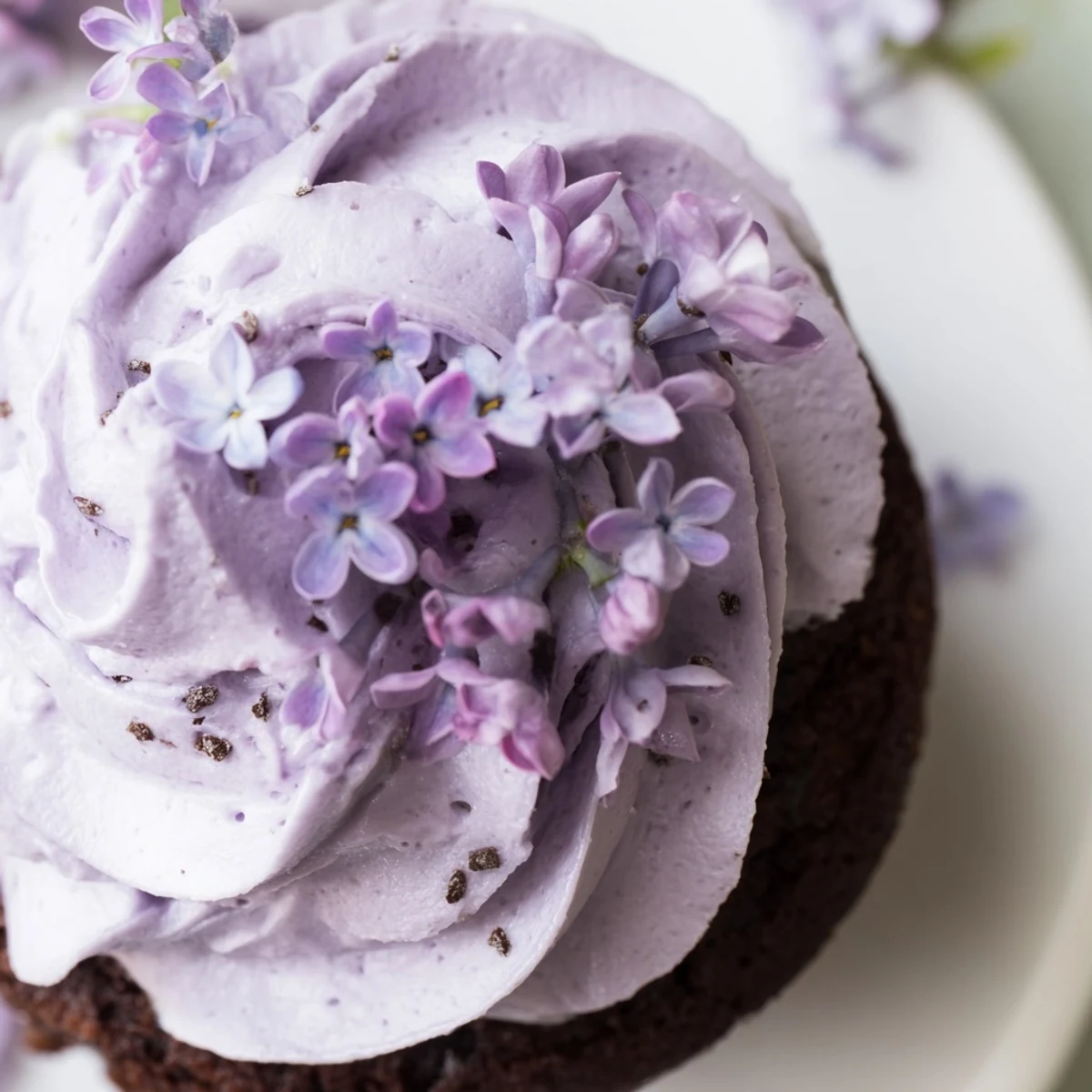Six chocolate cupcakes with lilac buttercream frosting arranged on a wooden board