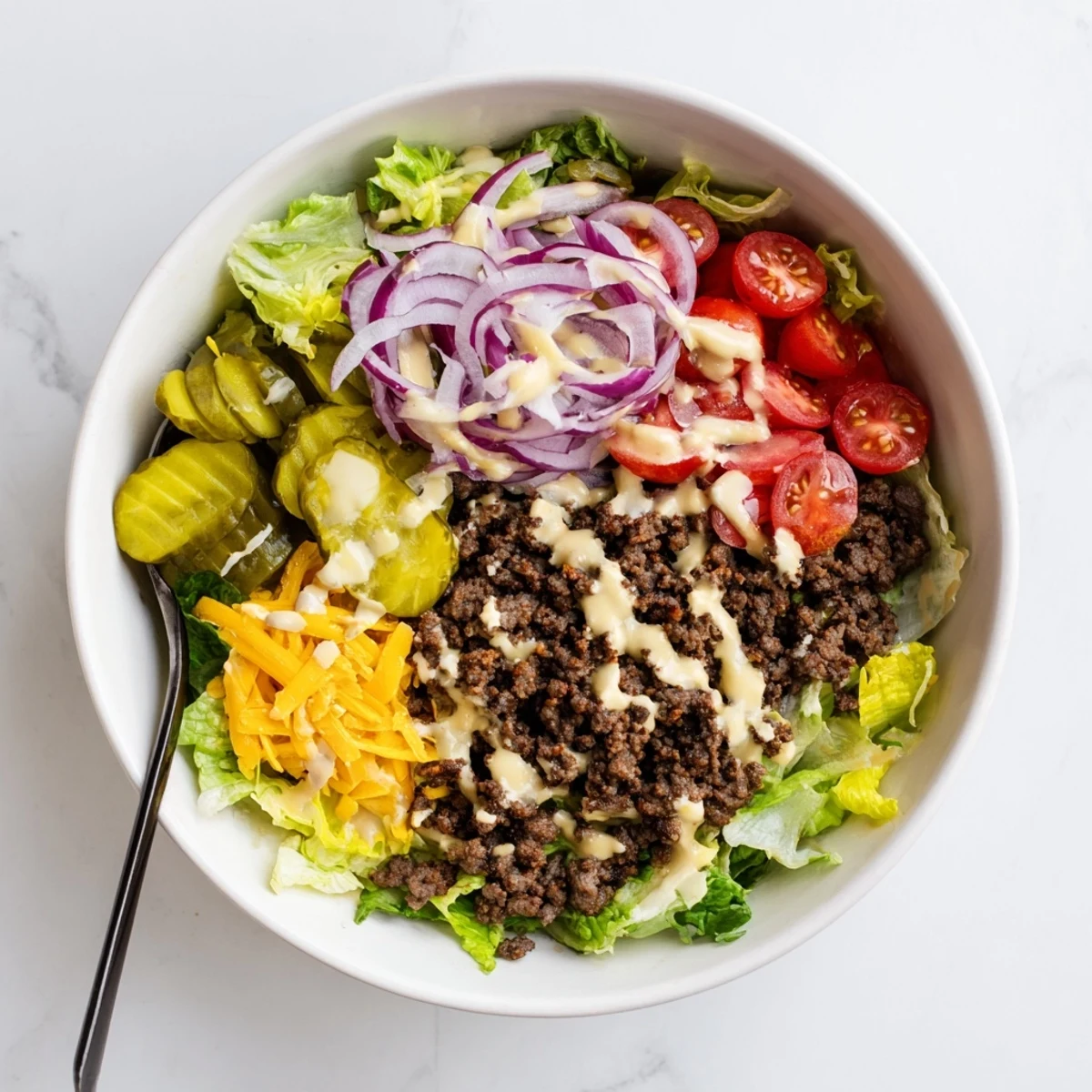 Deconstructed Burger Bowls featuring juicy seasoned beef over crisp lettuce with special sauce