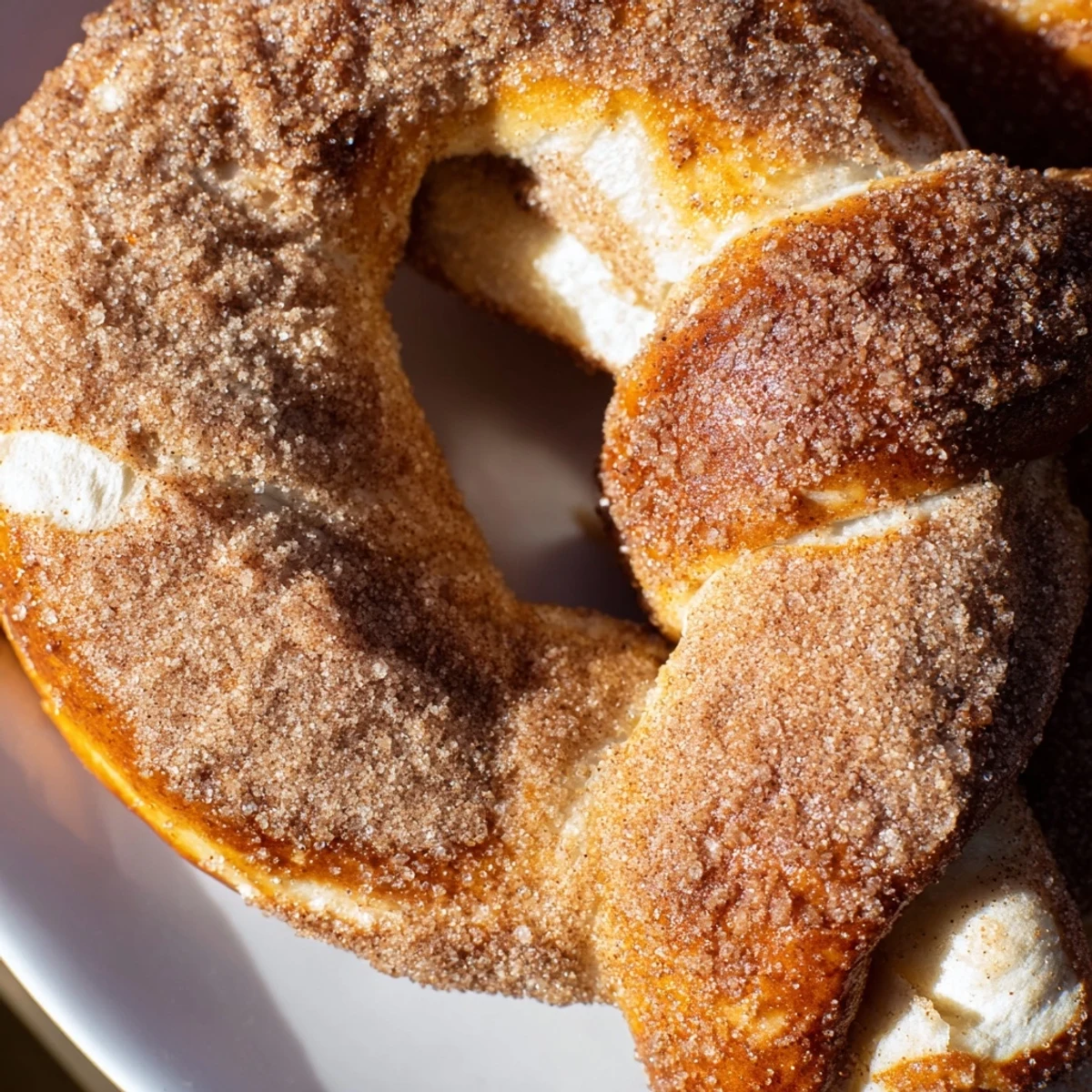 Warm homemade cinnamon sugar soft pretzels sprinkled with sweet spice on wooden board