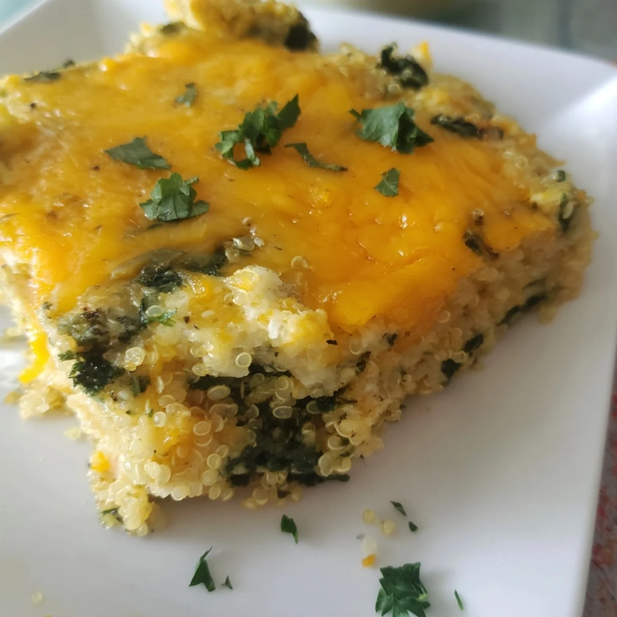 Wholesome breakfast casserole featuring baked eggs nestled between spinach and tender quinoa grains