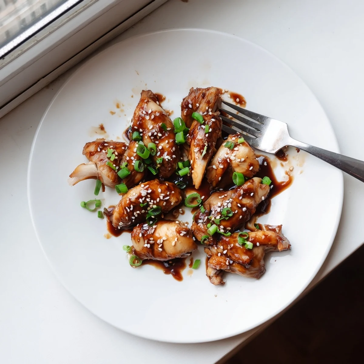 Tender Crockpot Teriyaki Chicken glazed in thick sticky sauce with sesame seeds