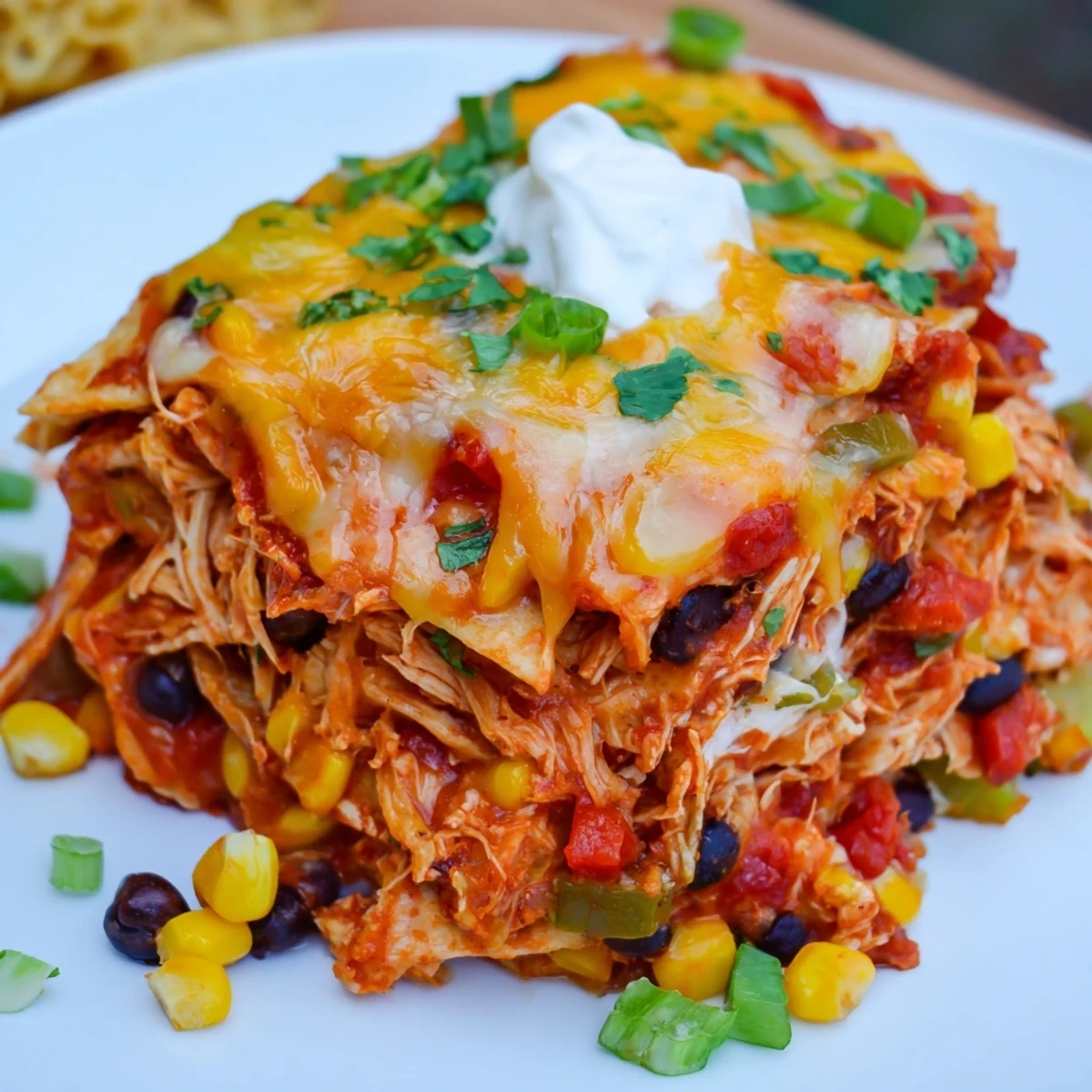 Golden cheese-covered chicken enchilada casserole served hot from the slow cooker with Tex-Mex toppings