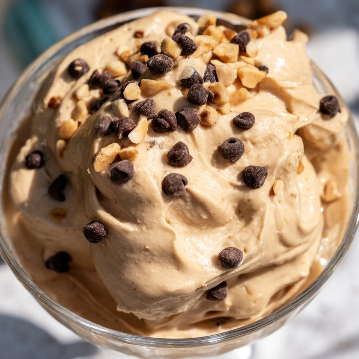 Light and airy peanut butter Cool Whip mousse served chilled with chocolate chip and peanut toppings