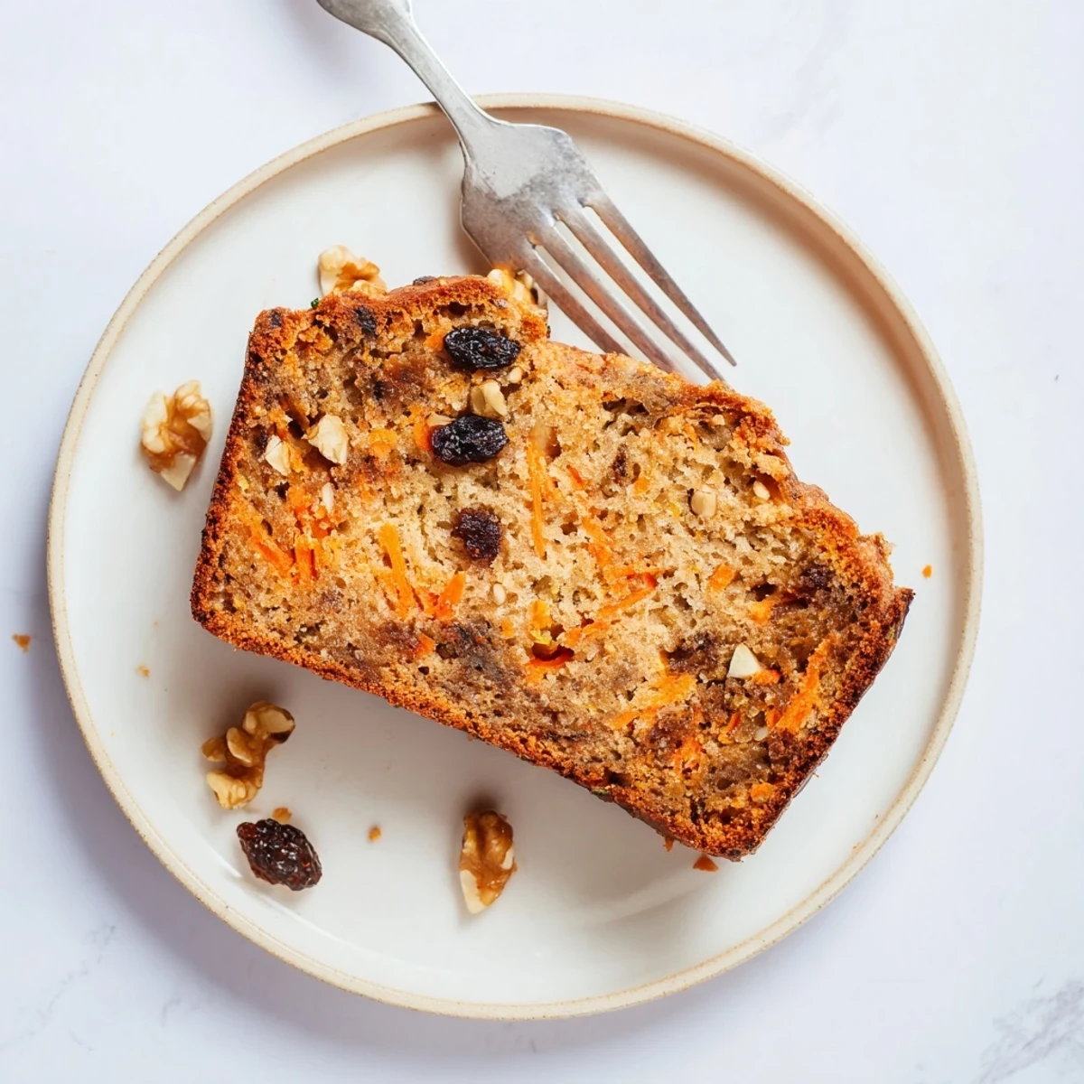 Freshly baked carrot cake banana bread loaf cooling on wire rack with golden brown crust and tender textured interior