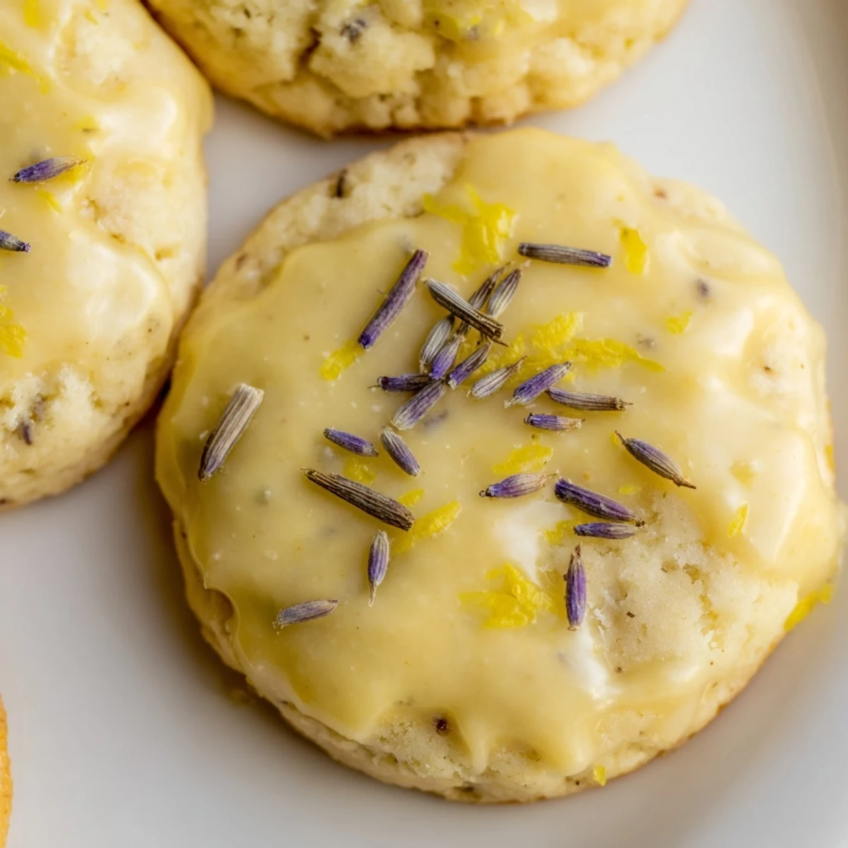 Buttery Iced Lemon Lavender Shortbread Cookies with golden edges and fragrant lavender sprinkles