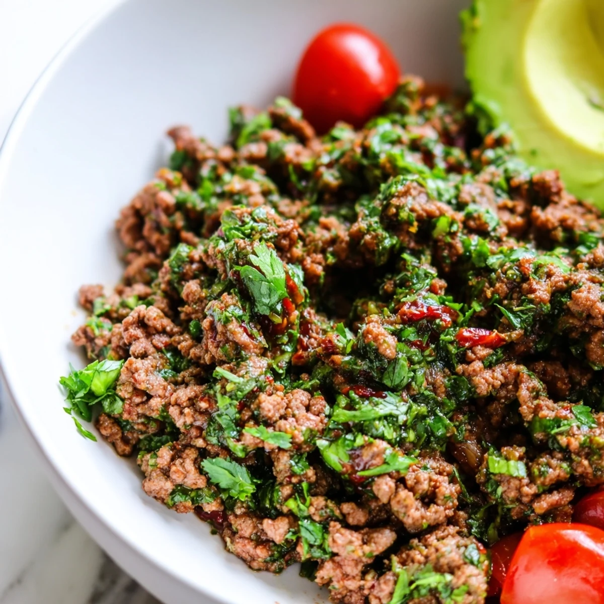 Sizzling spiced chimichurri ground beef bowls loaded with crisp cucumber tomatoes and creamy avocado slices