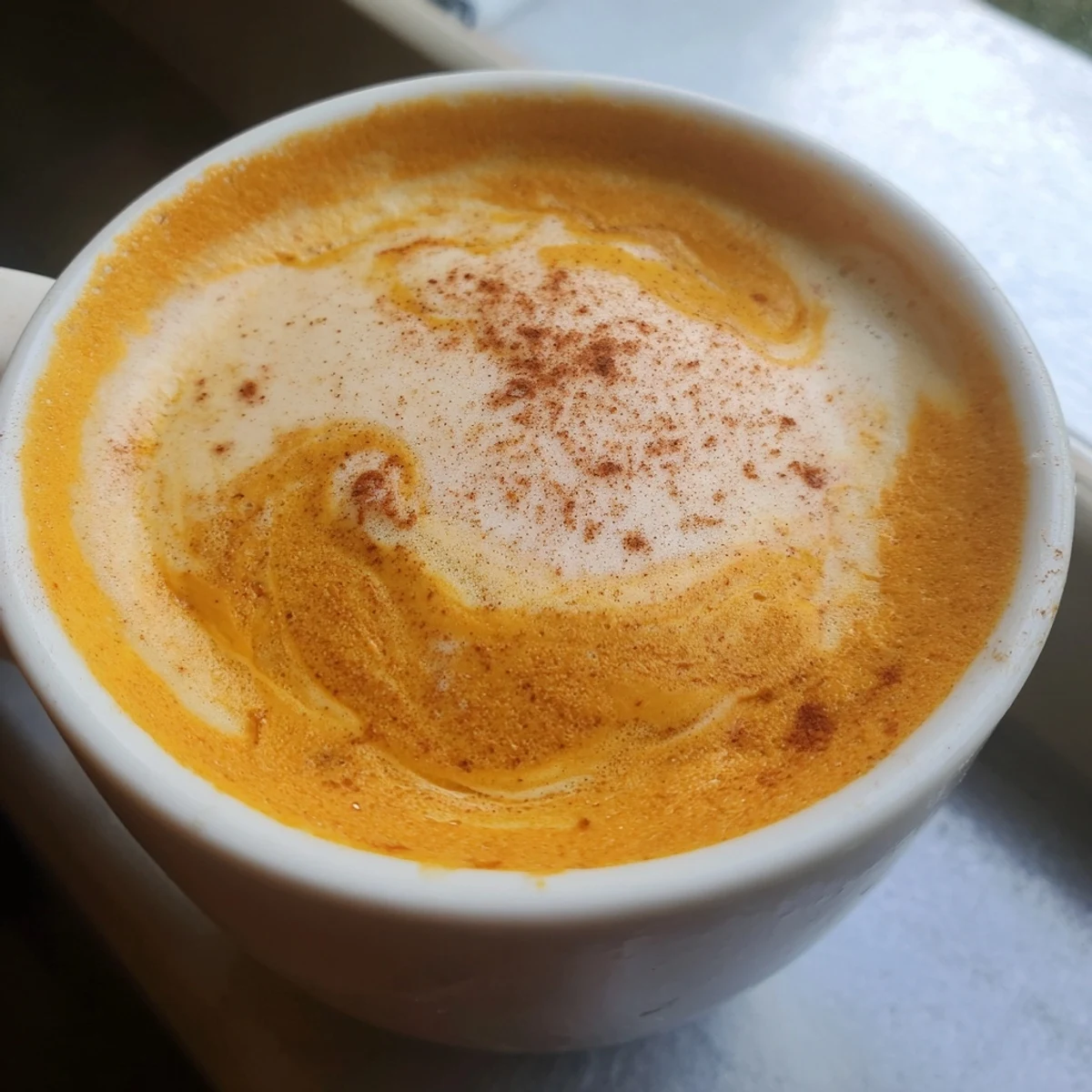 Creamy Goguma Latte in a warm mug topped with a dusting of cinnamon