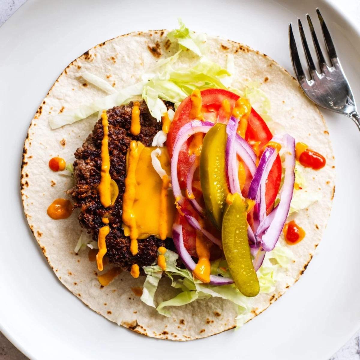 Plated Smash Burger Tacos Recipe with crisp lettuce, pickles, and burger sauce