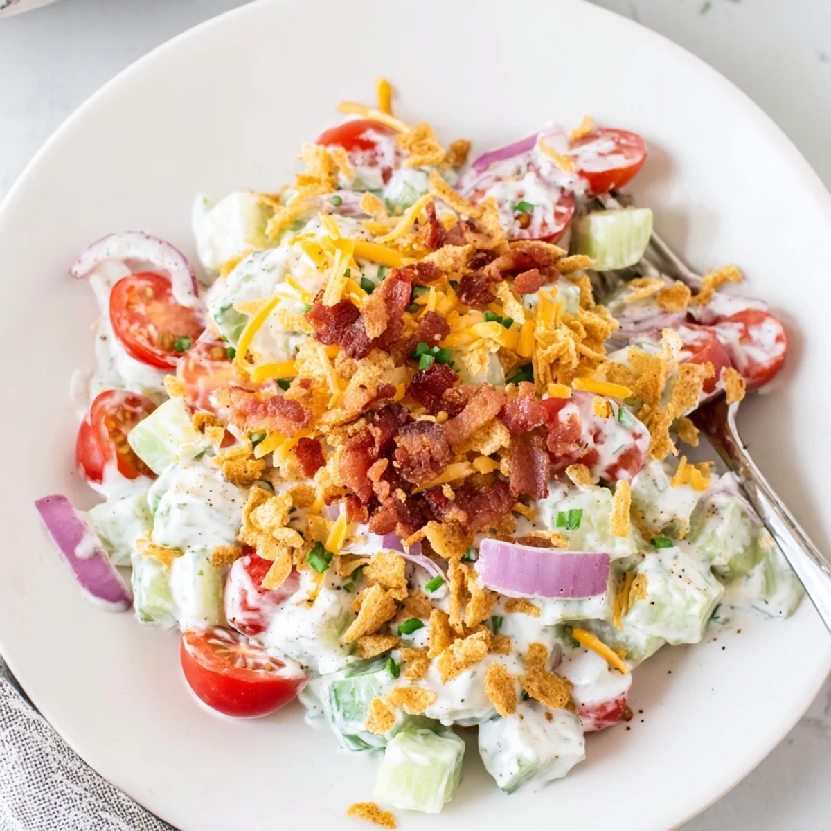 Cucumber Ranch Crack Salad piled high with crispy bacon and cheddar