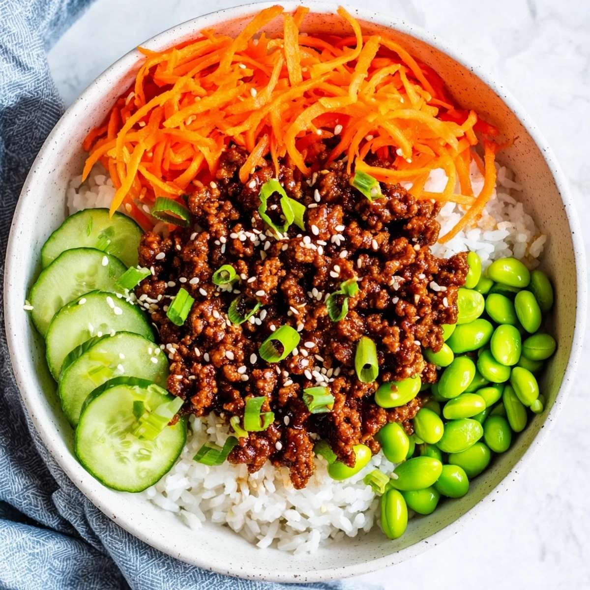 Golden ground beef glazed in spicy hot honey over fluffy rice with fresh vegetables