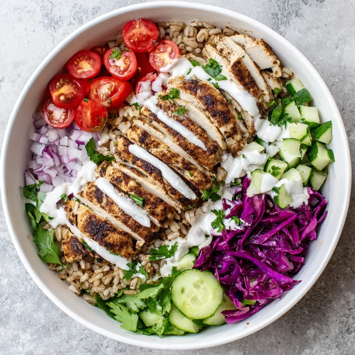 Nutritious chicken shawarma bowl featuring marinated meat, crisp veggies, and velvety yogurt dressing