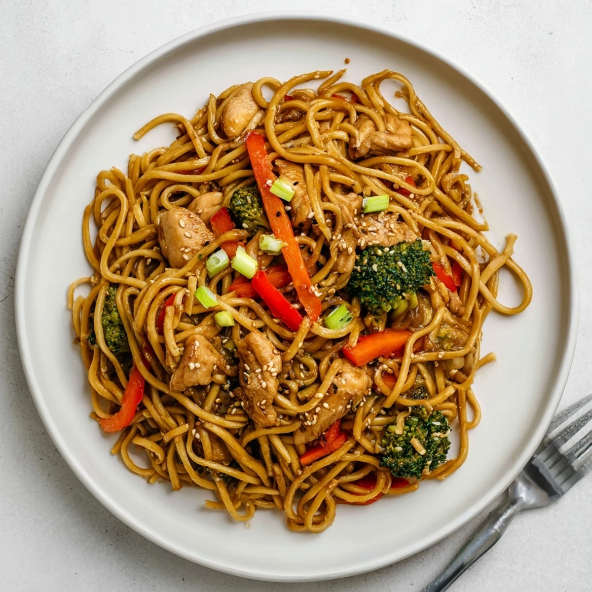 Family style Savory Garlic Chicken Lo Mein Delight piled high on a platter