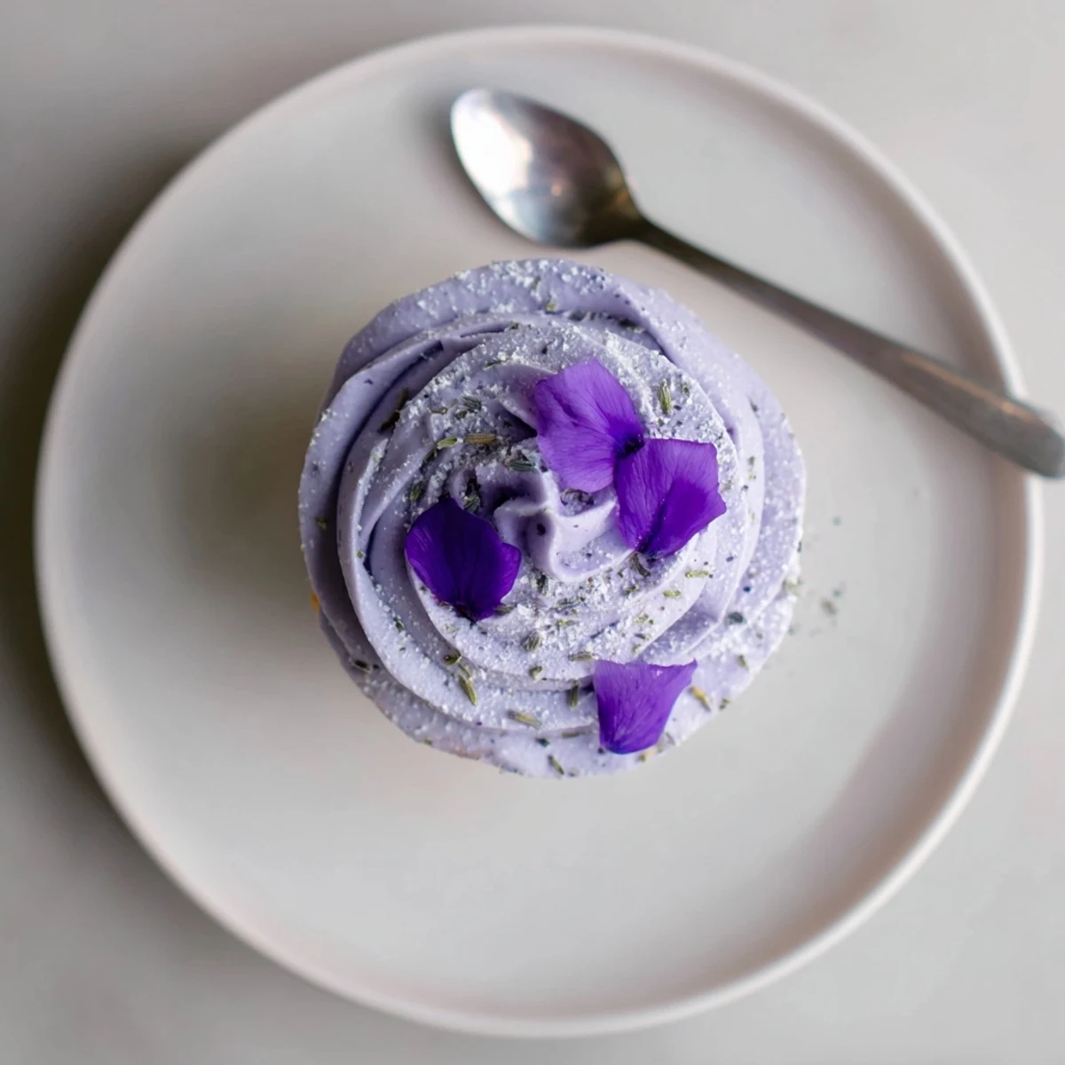 Lavender Buttercream Floral Frosting piped into pale purple swirls on cupcakes