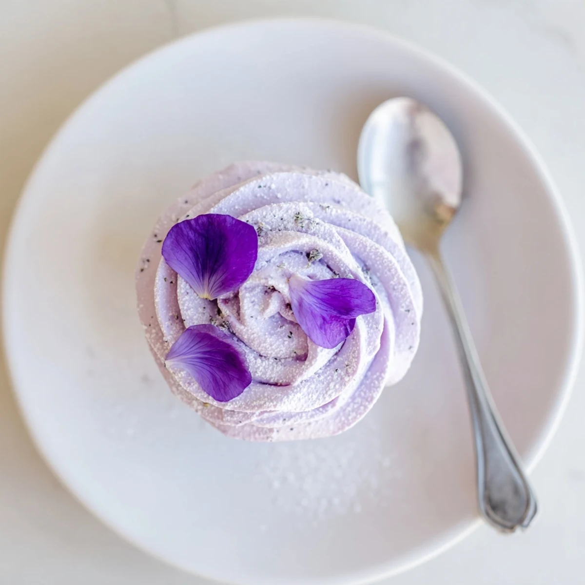 Soft, aromatic Lavender Buttercream Floral Frosting spread over a cooled vanilla cake