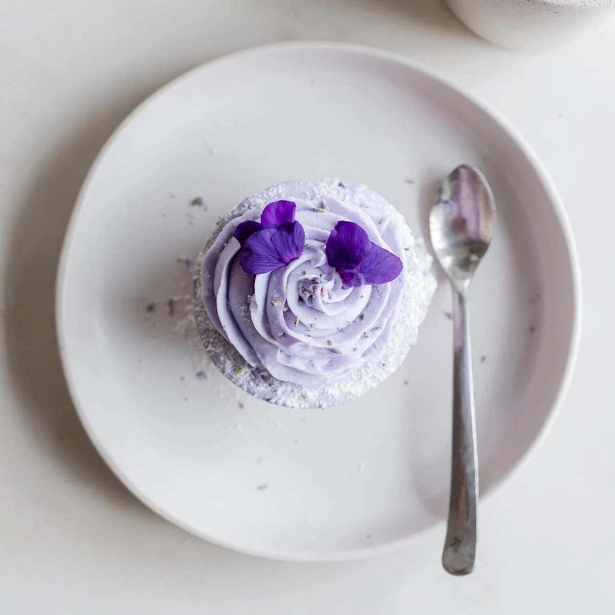 Garnished with edible pansies, Lavender Buttercream Floral Frosting smells floral and silky