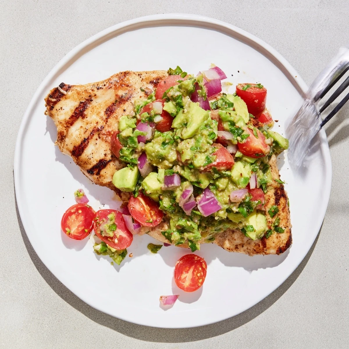 Smoky charred, glistening slices of Juicy Grilled California Avocado Chicken.