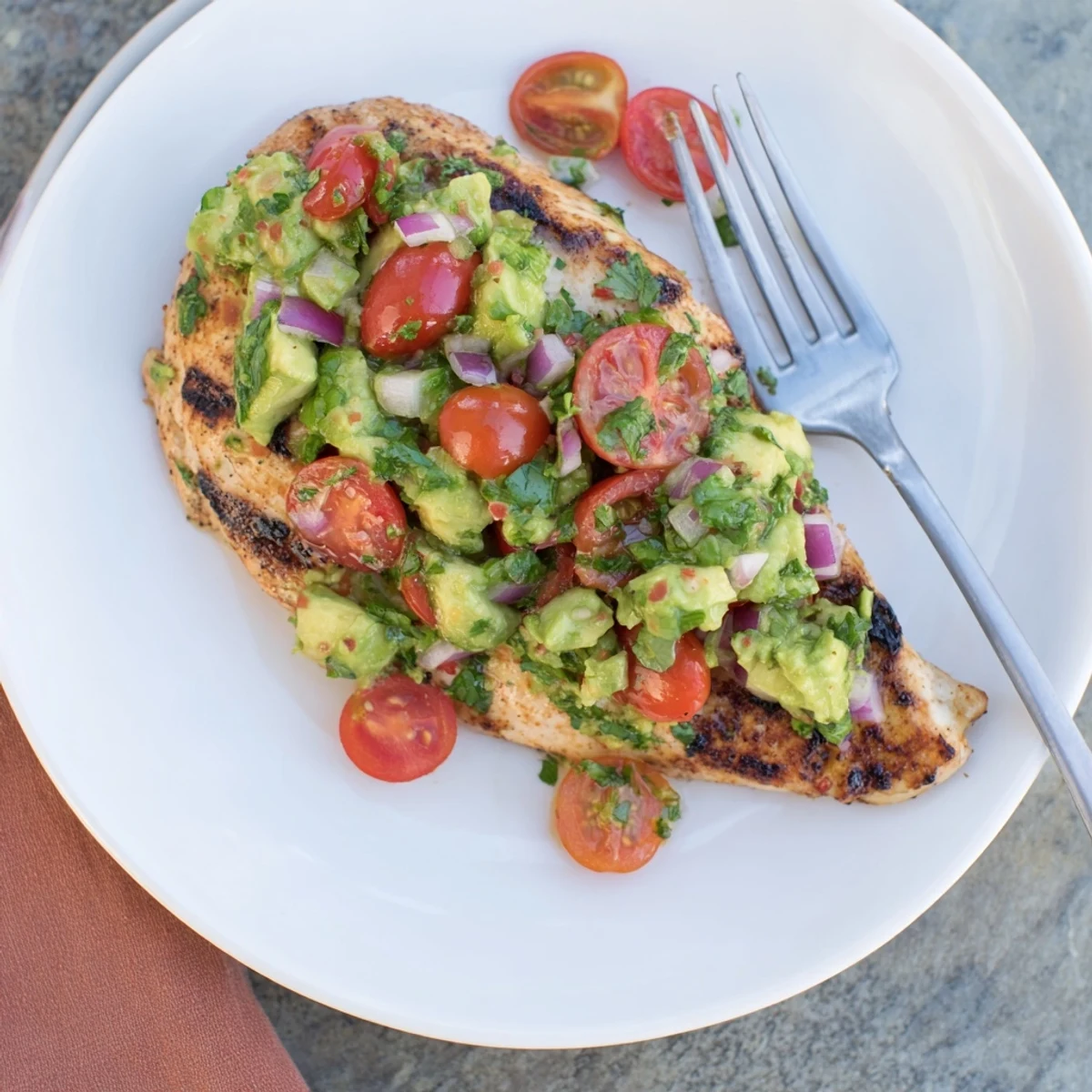 Bright summer salad served alongside Juicy Grilled California Avocado Chicken for dinner.