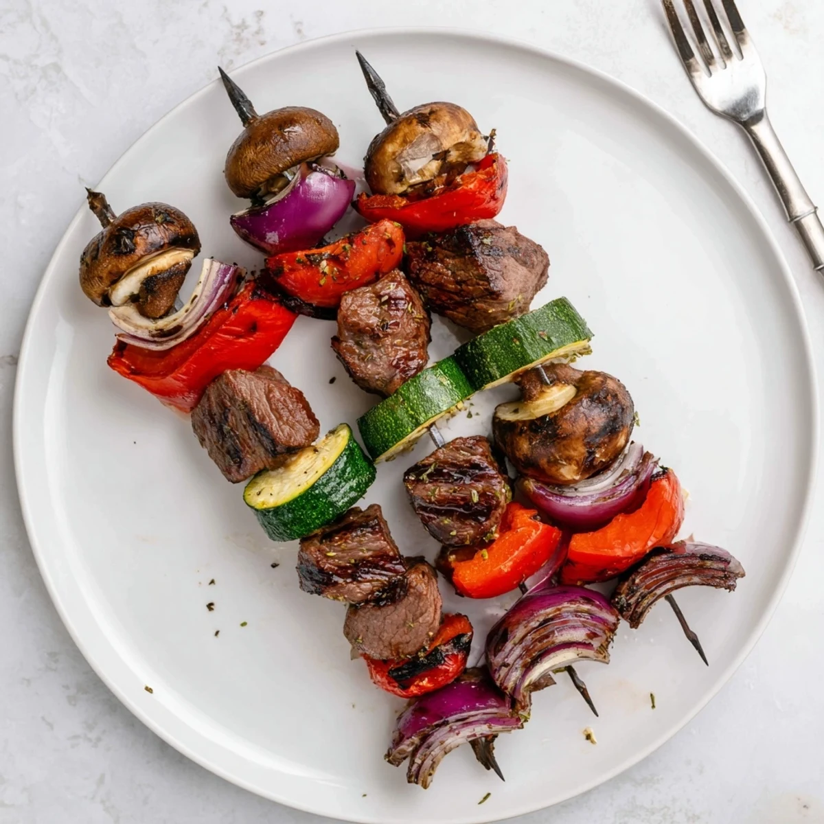 Grilled Steak Kabobs sizzling with charred vegetables, ready for summer grilling