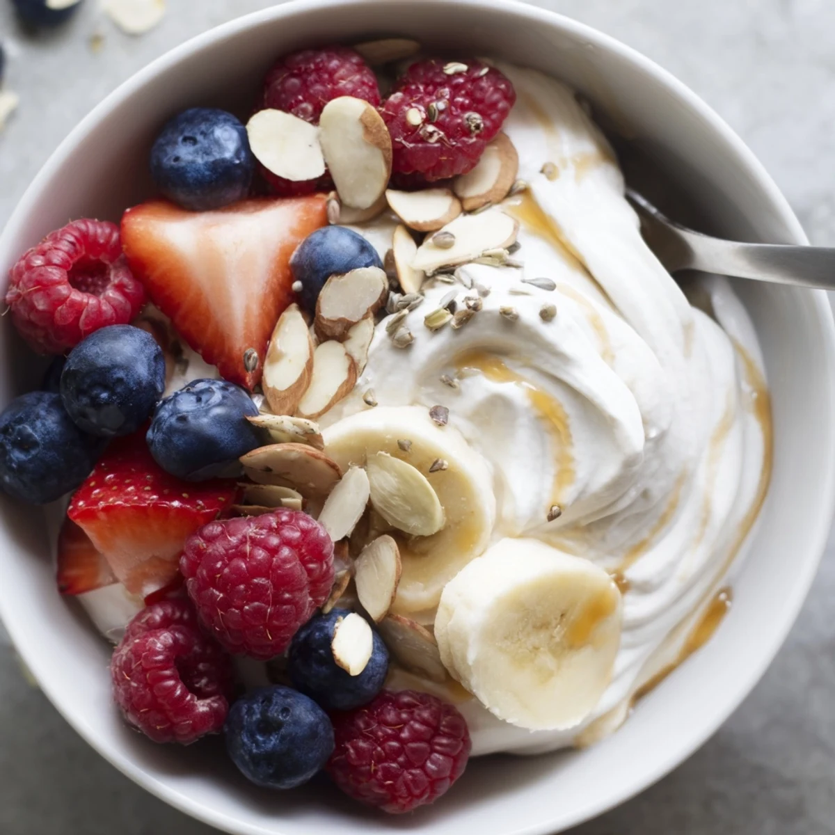 High Protein Greek Yogurt Bowl layered with fresh berries, crunchy almonds, honey  