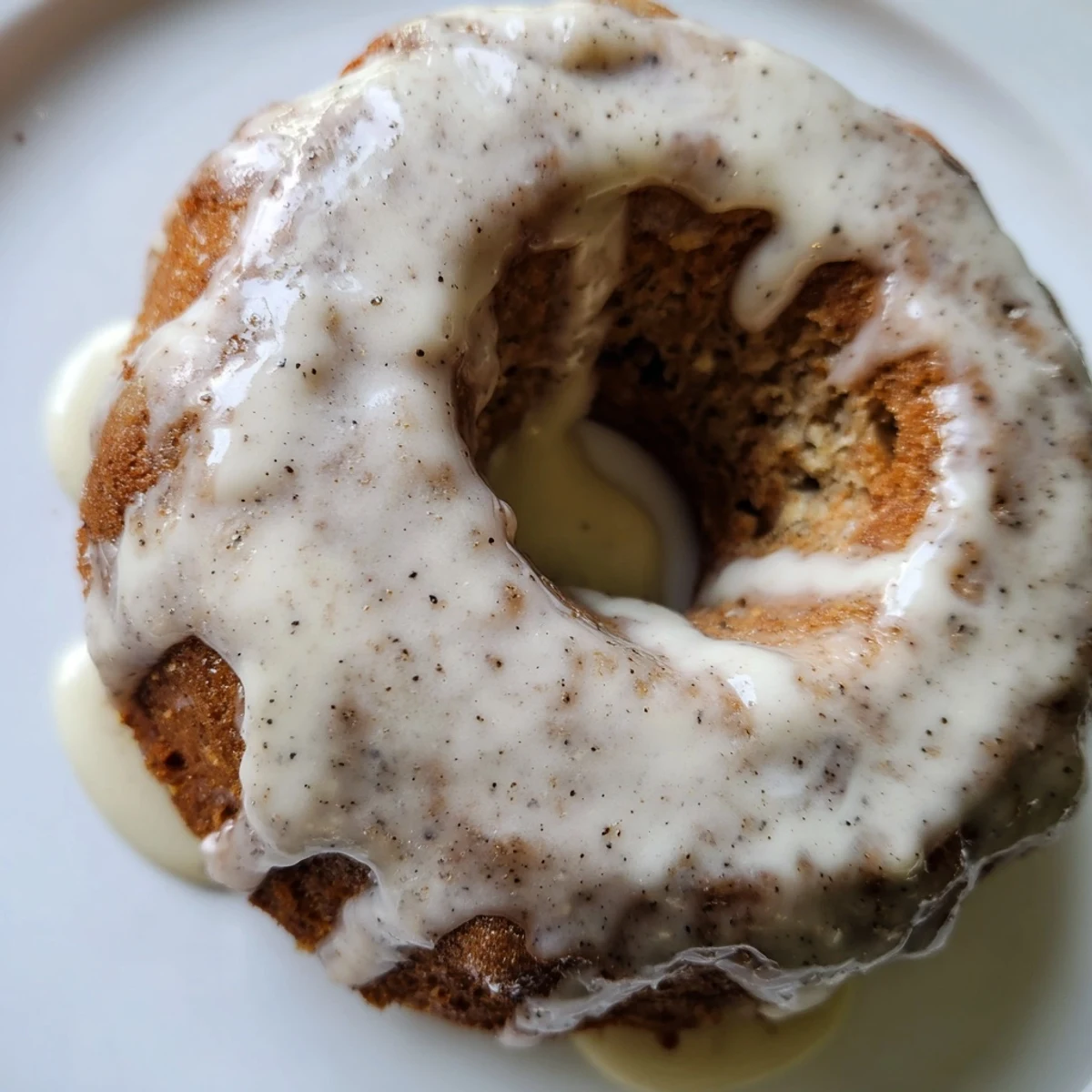 Moist baked banana bread donuts fresh from the oven with vanilla glaze drizzle