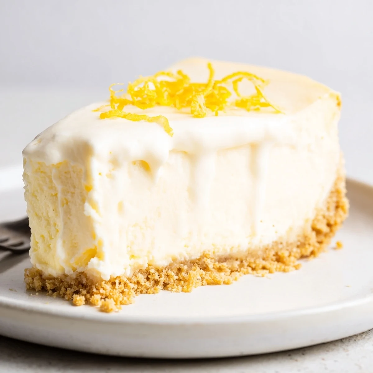 Classic Cheesecake with smooth, creamy filling on buttery graham crust, sliced