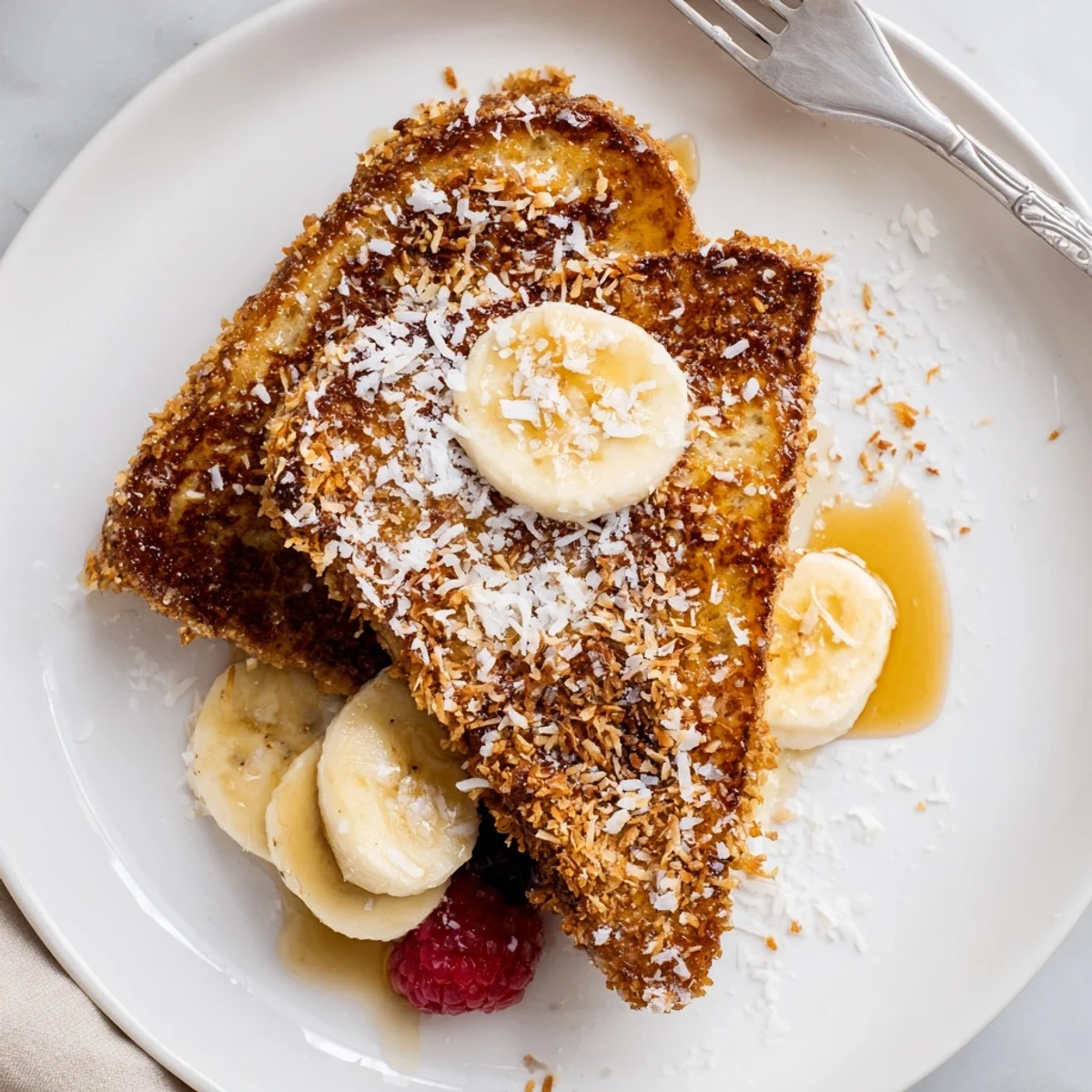 Stacked Coconut Crusted French Toast, buttery edges and powdered sugar dusting
