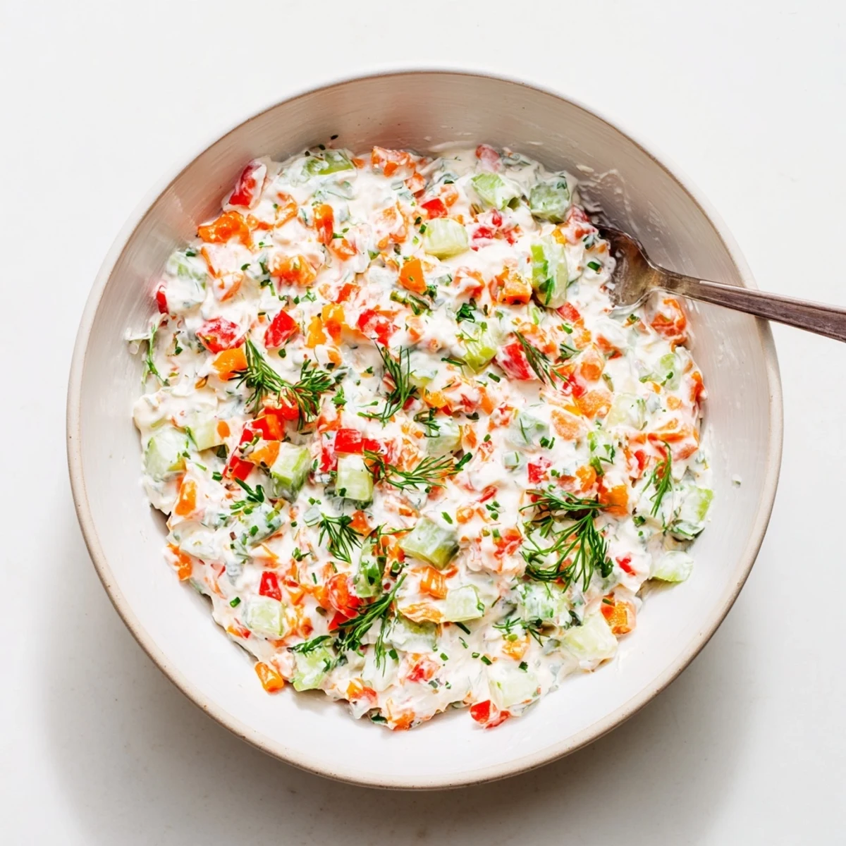 Vibrant garden vegetable spread recipe featuring crisp red bell pepper and cucumber blended into smooth cream cheese