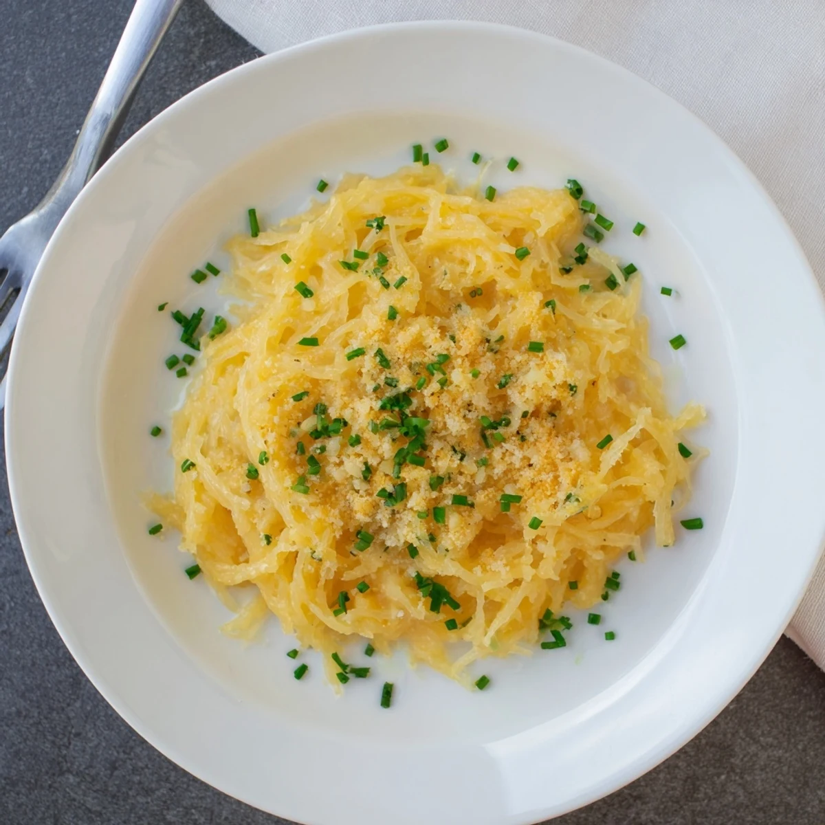 Golden roasted spaghetti squash strands coated in rich creamy cheddar cheese sauce