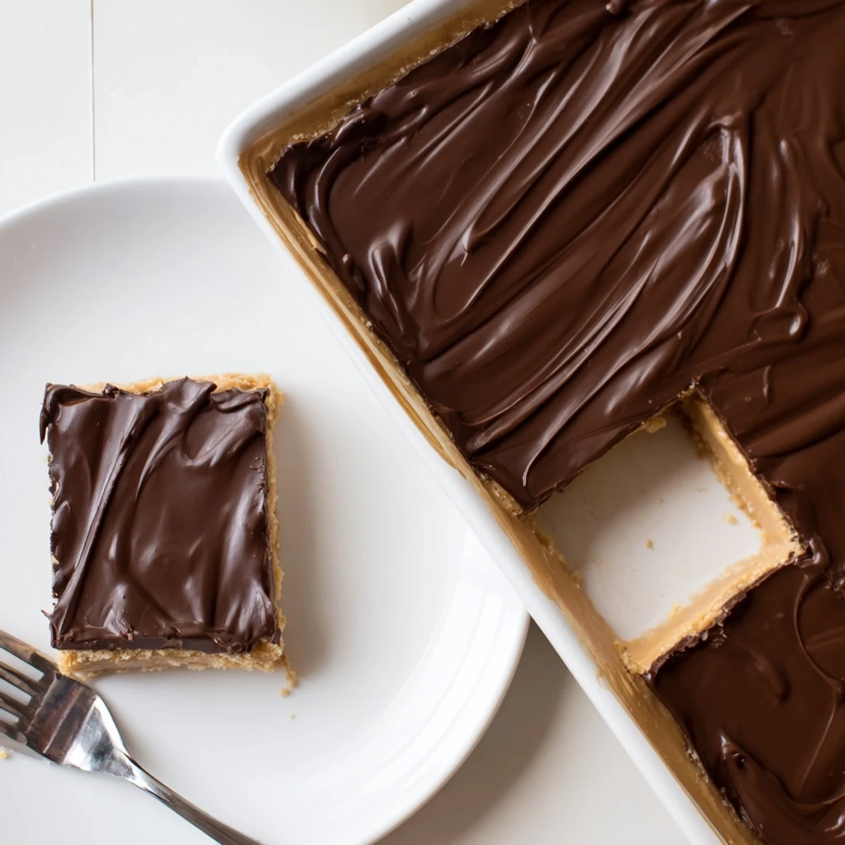 Homemade Peanut Butter Bars no-bake treat, rich, dense squares on plate.