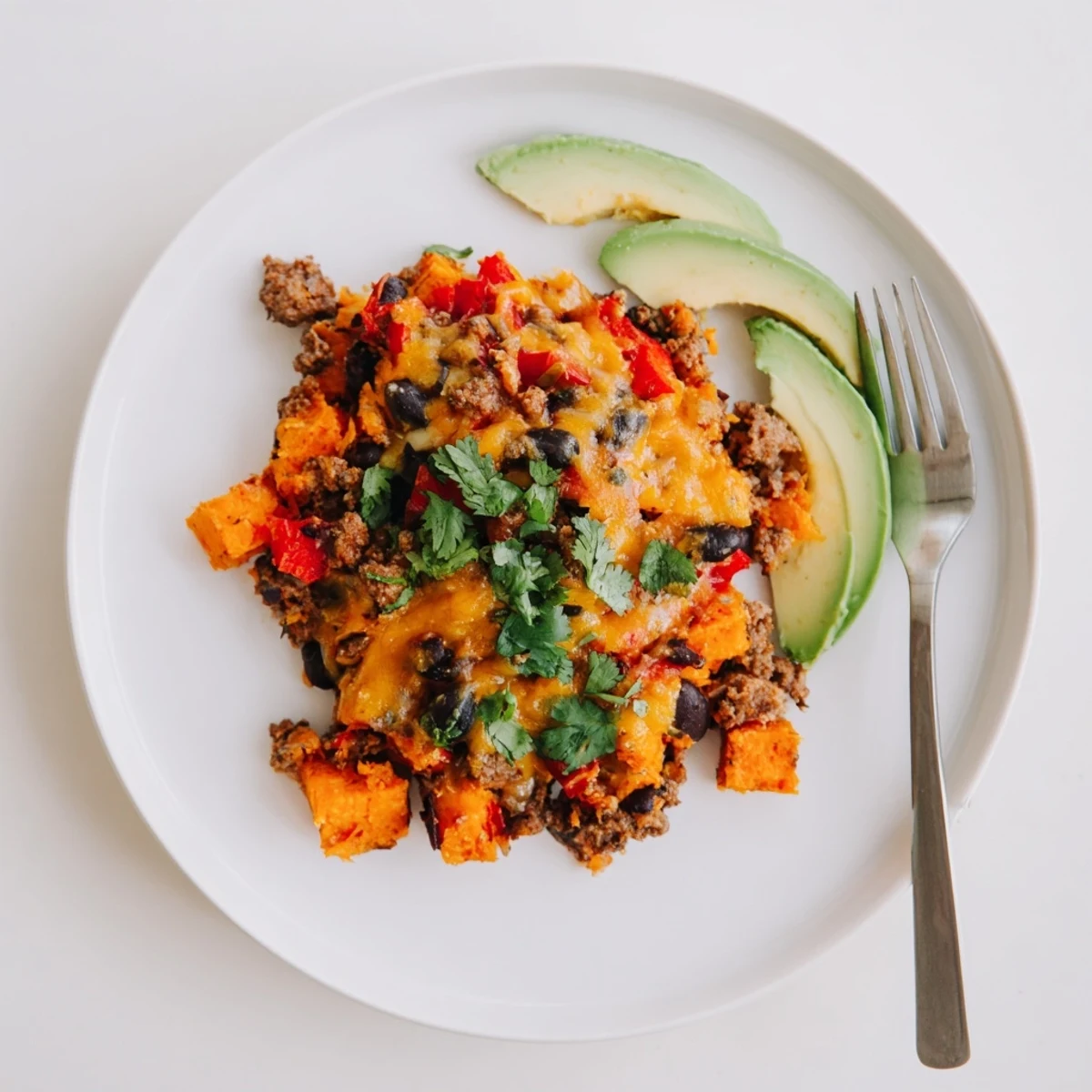 Golden bubbly sweet potato turkey black bean bake fresh from the oven with melted cheese topping
