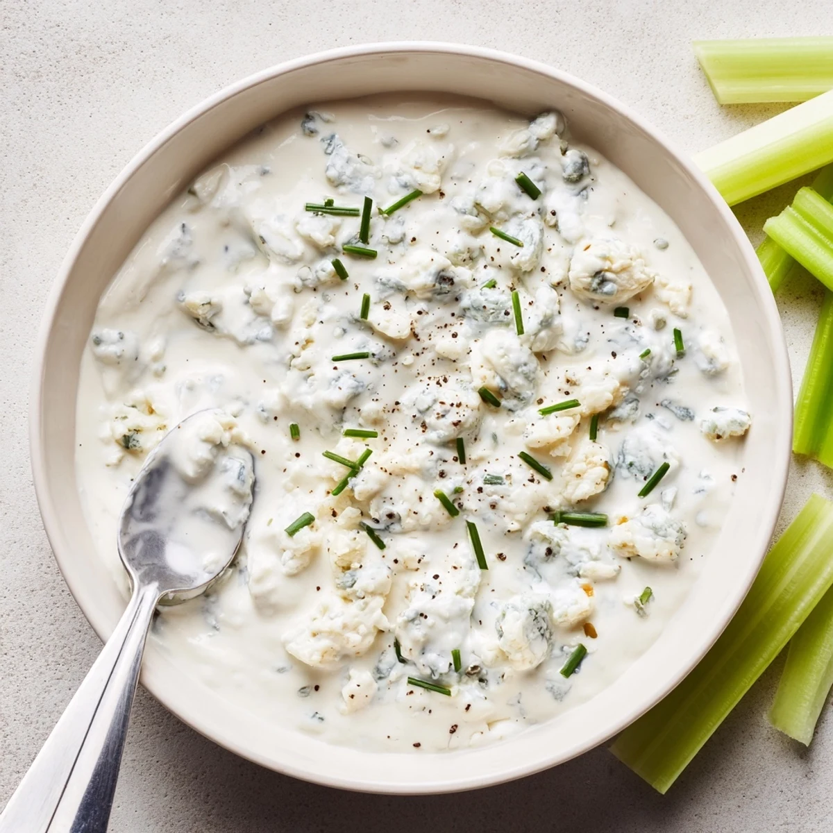 Thick blue cheese dip swirled with crumbles and topped with fresh chives