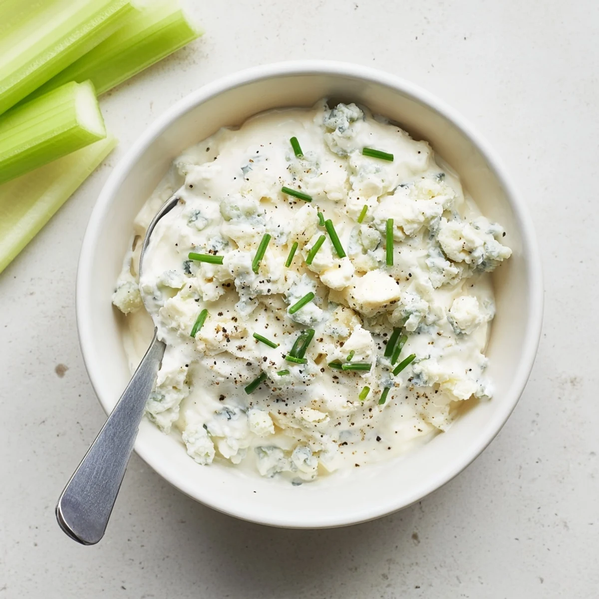 Velvety blue cheese dip served alongside buffalo wings and crunchy carrot sticks