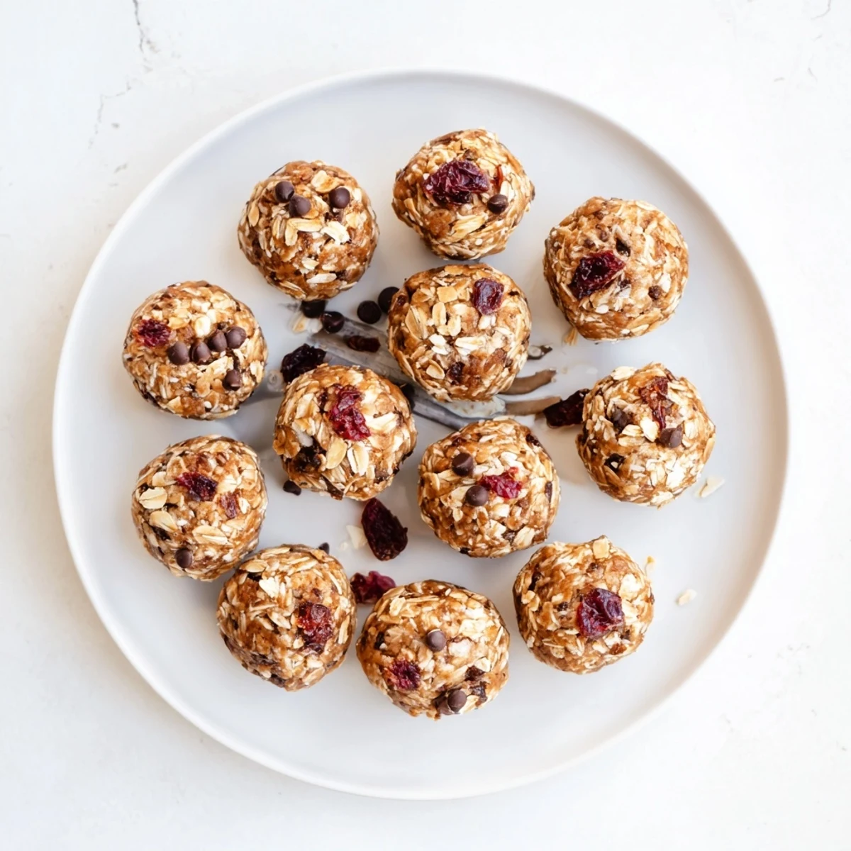 Vegan date energy balls stacked on white plate, naturally sweet and nutrient-dense