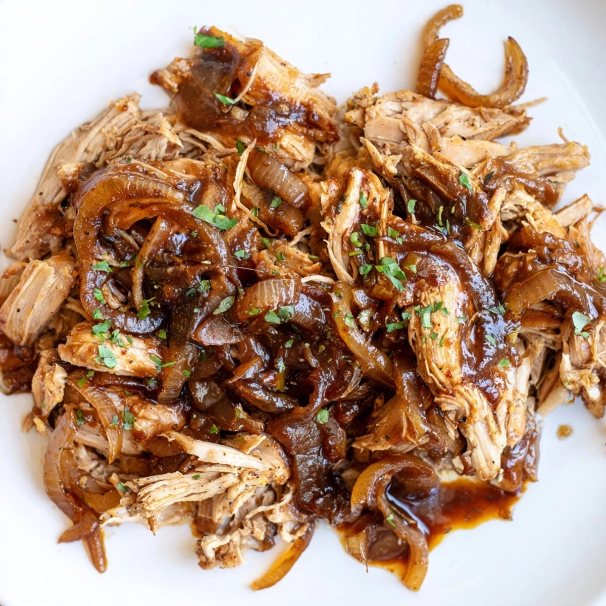 Slow cooker balsamic chicken served over tender onions with a glossy thick glaze