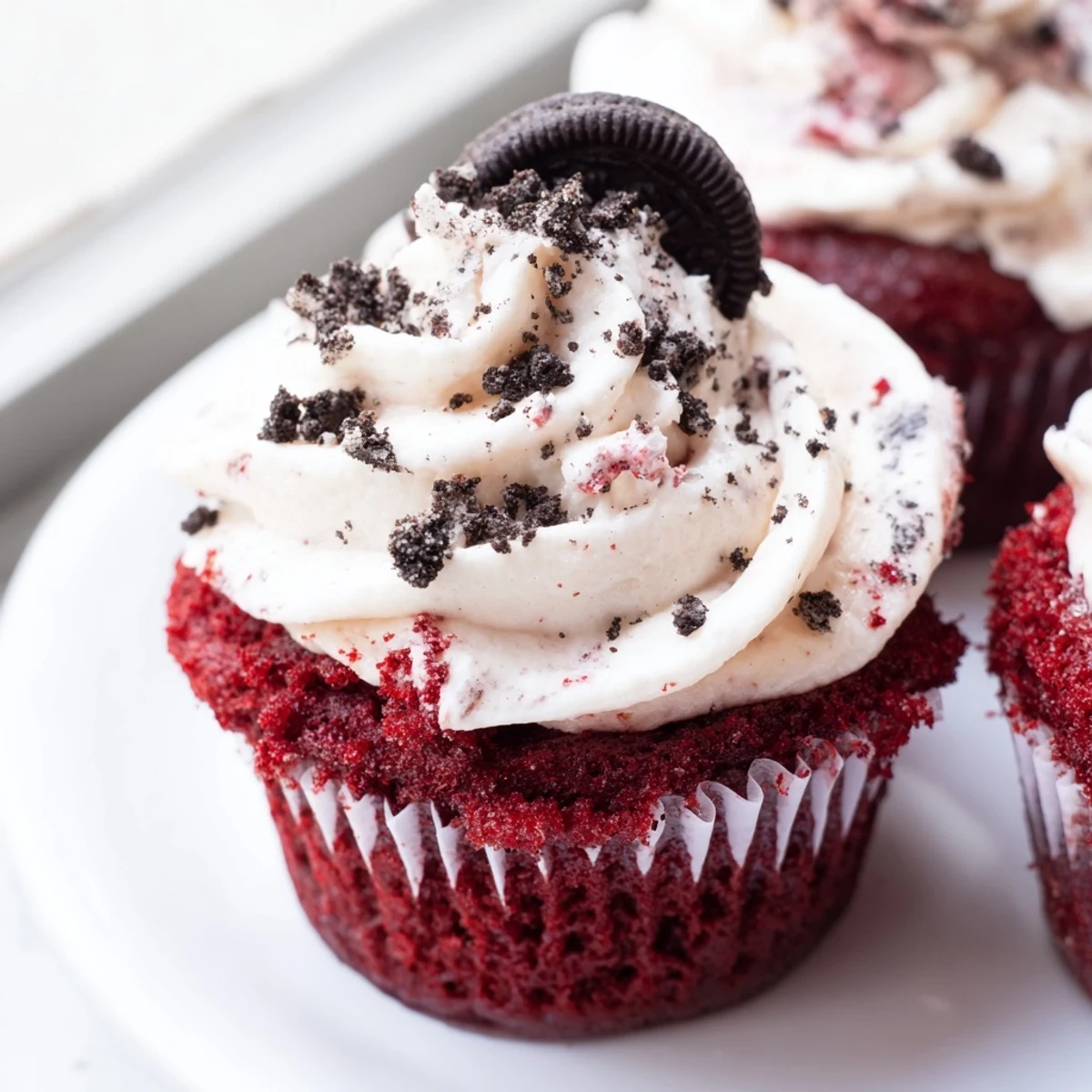Crumbed Oreo garnish on Red Velvet Oreo Cupcakes with swirled cream cheese frosting