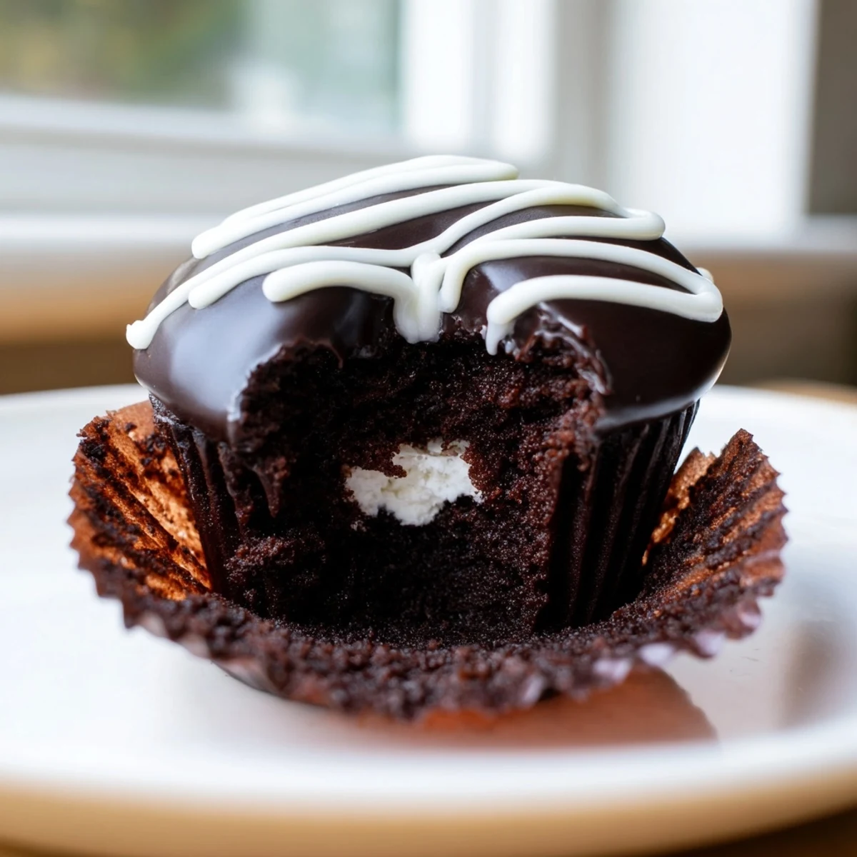 Homemade Hostess Cupcakes featuring creamy marshmallow centers and signature icing squiggles