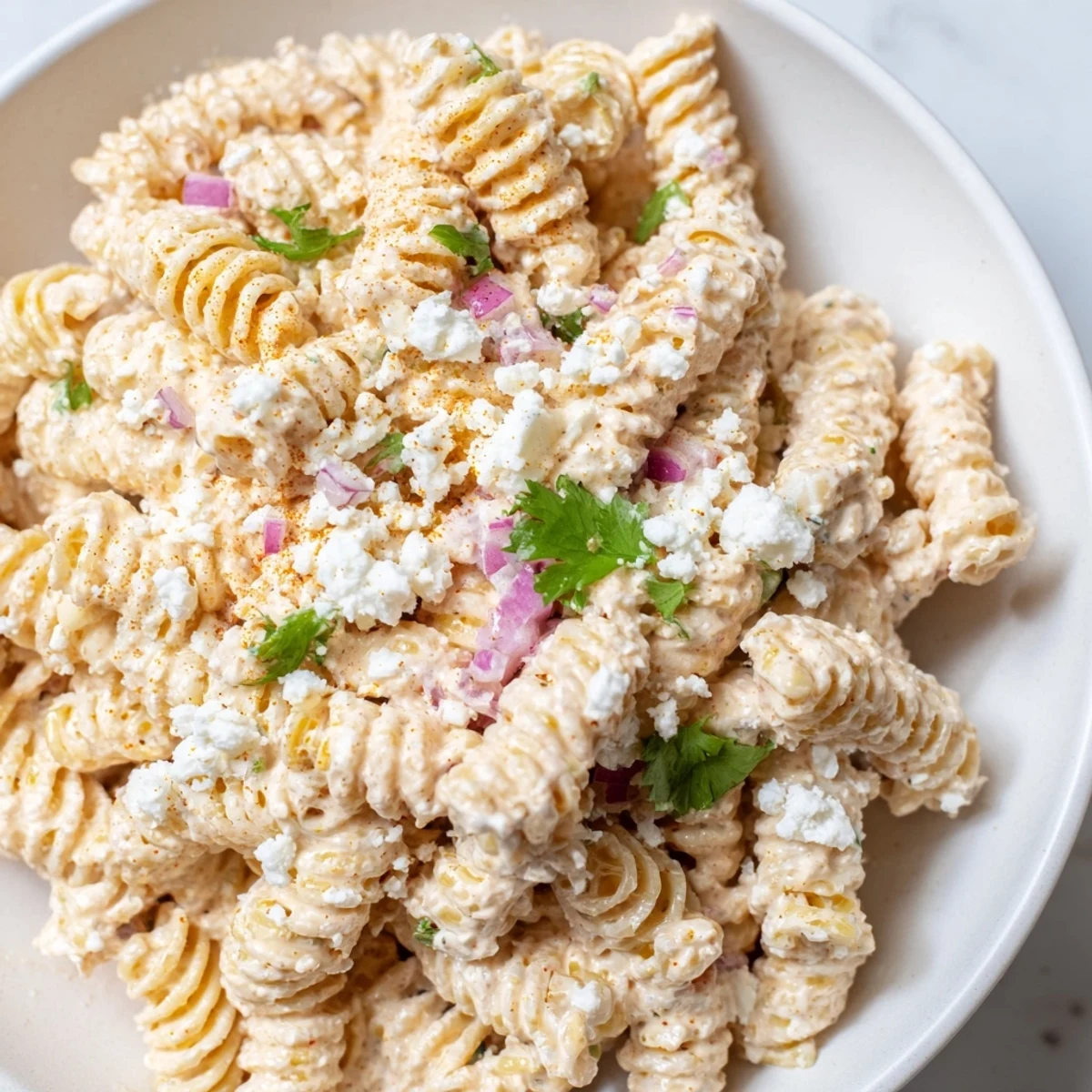 Bright elote pasta salad in a smoky lime dressing with sweet golden corn kernels