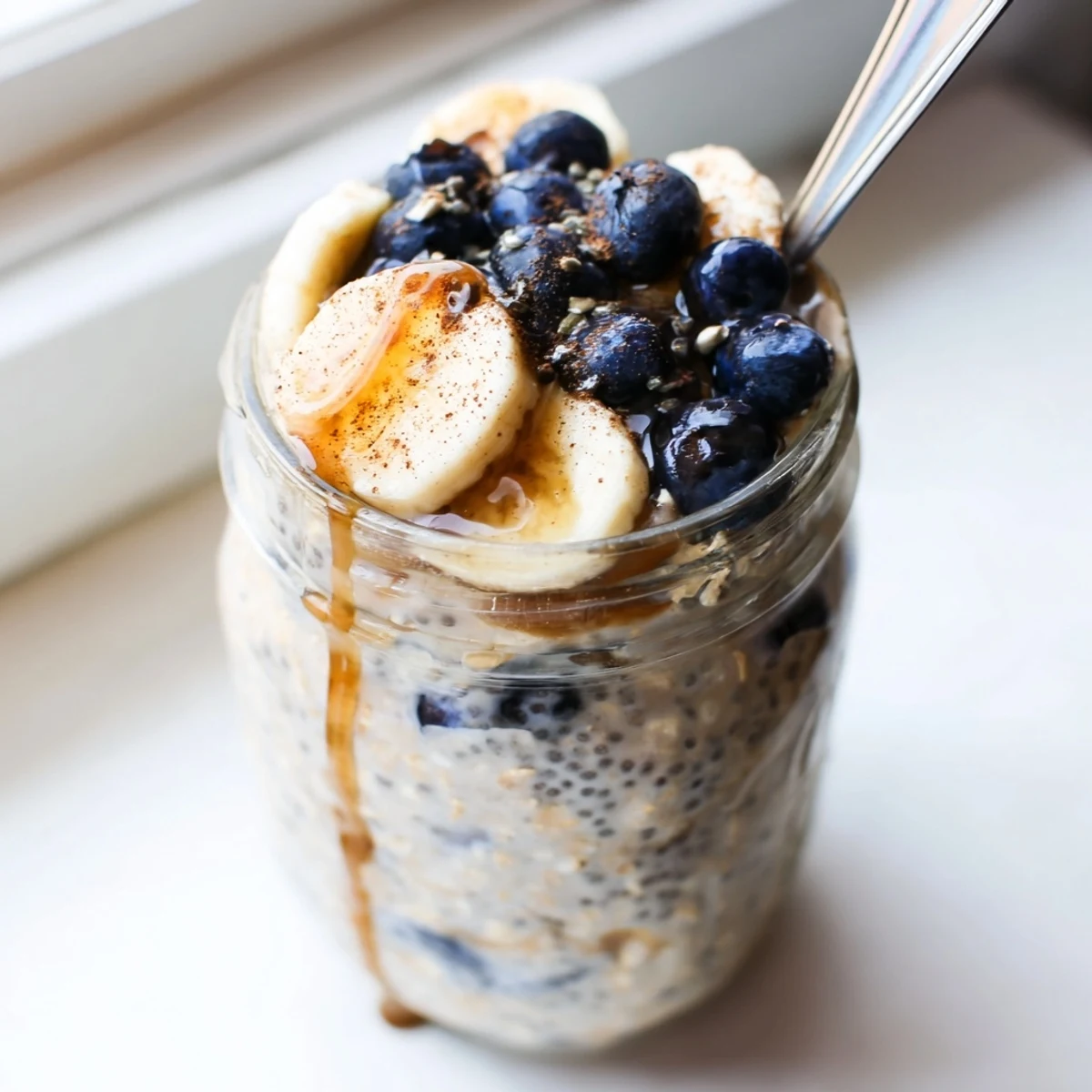 Creamy protein overnight oats topped with fresh berries in a glass jar