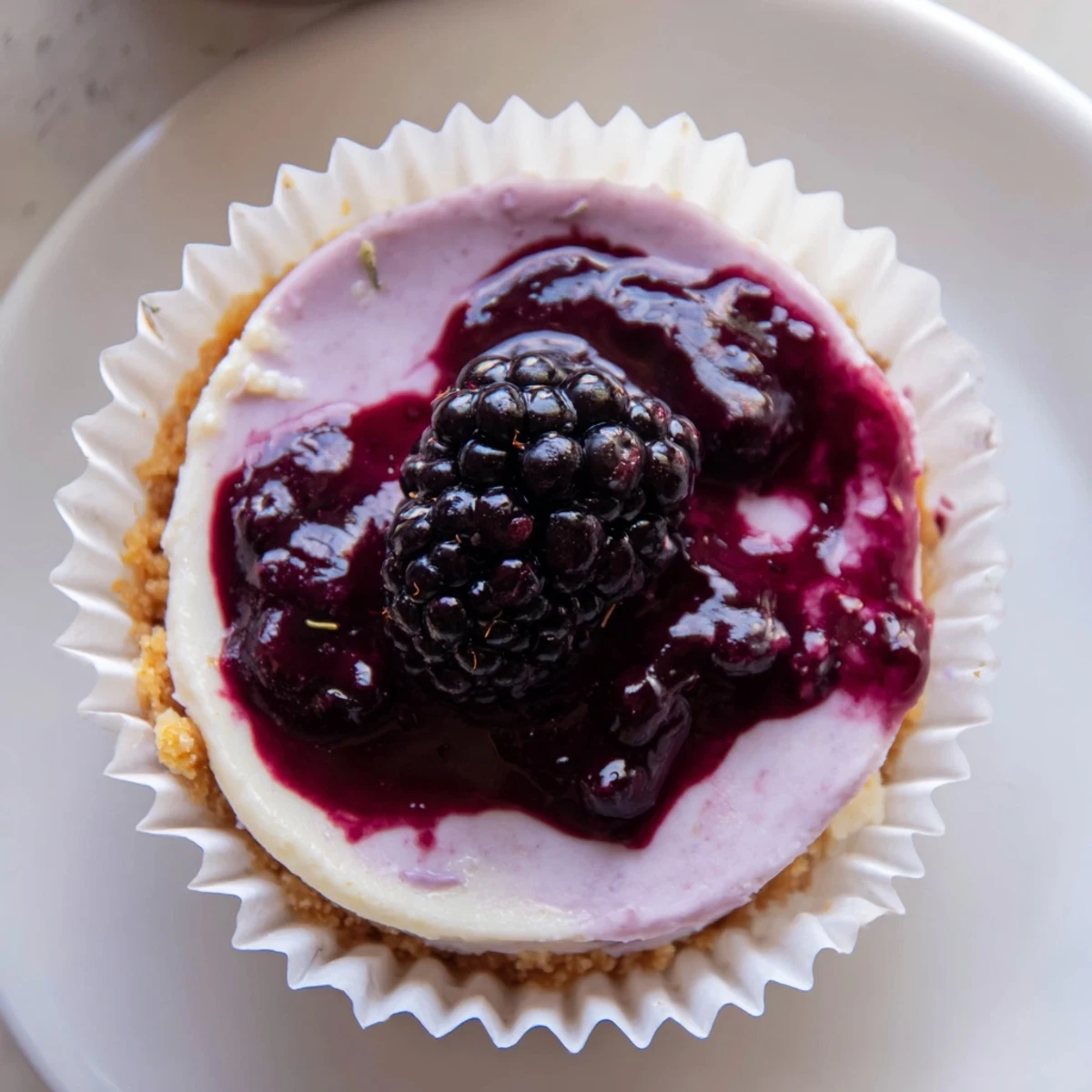 Creamy No Bake Mini Blackberry Lavender Cheesecakes topped with glistening berry sauce