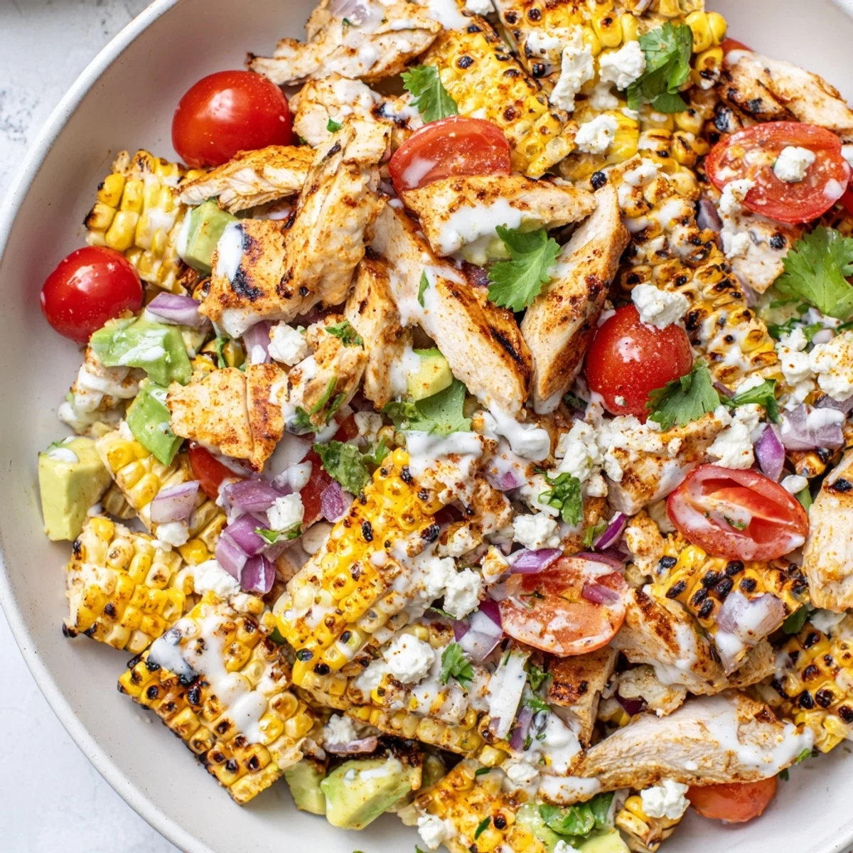 Creamy High Protein Chicken Street Corn Salad topped with crumbled cotija cheese and fresh cilantro