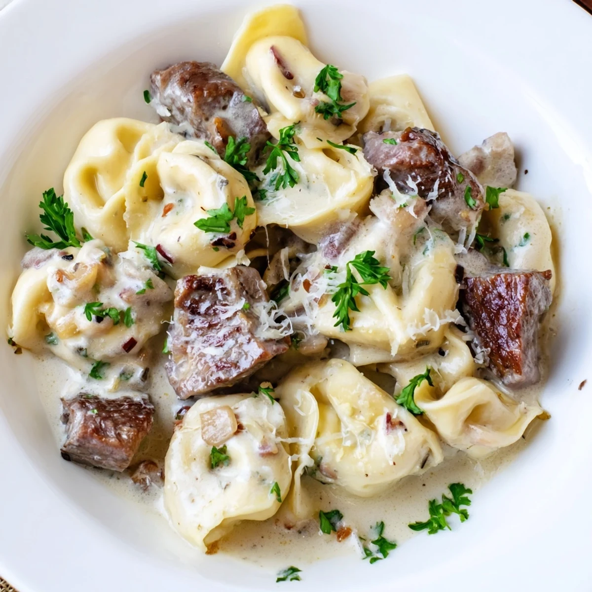 Golden seared steak tossed with plump tortellini in a rich garlic parmesan cream sauce