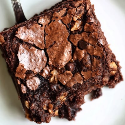 Warm ultimate brownies served on a plate with vanilla ice cream